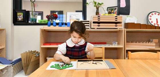 a child exploring the Sensorial area at a montessori